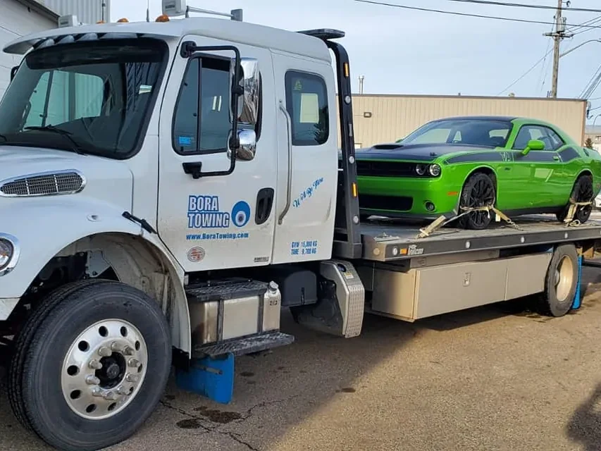 Bora Towing flatbed with a green Dodge Challenger sports car in Edmonton