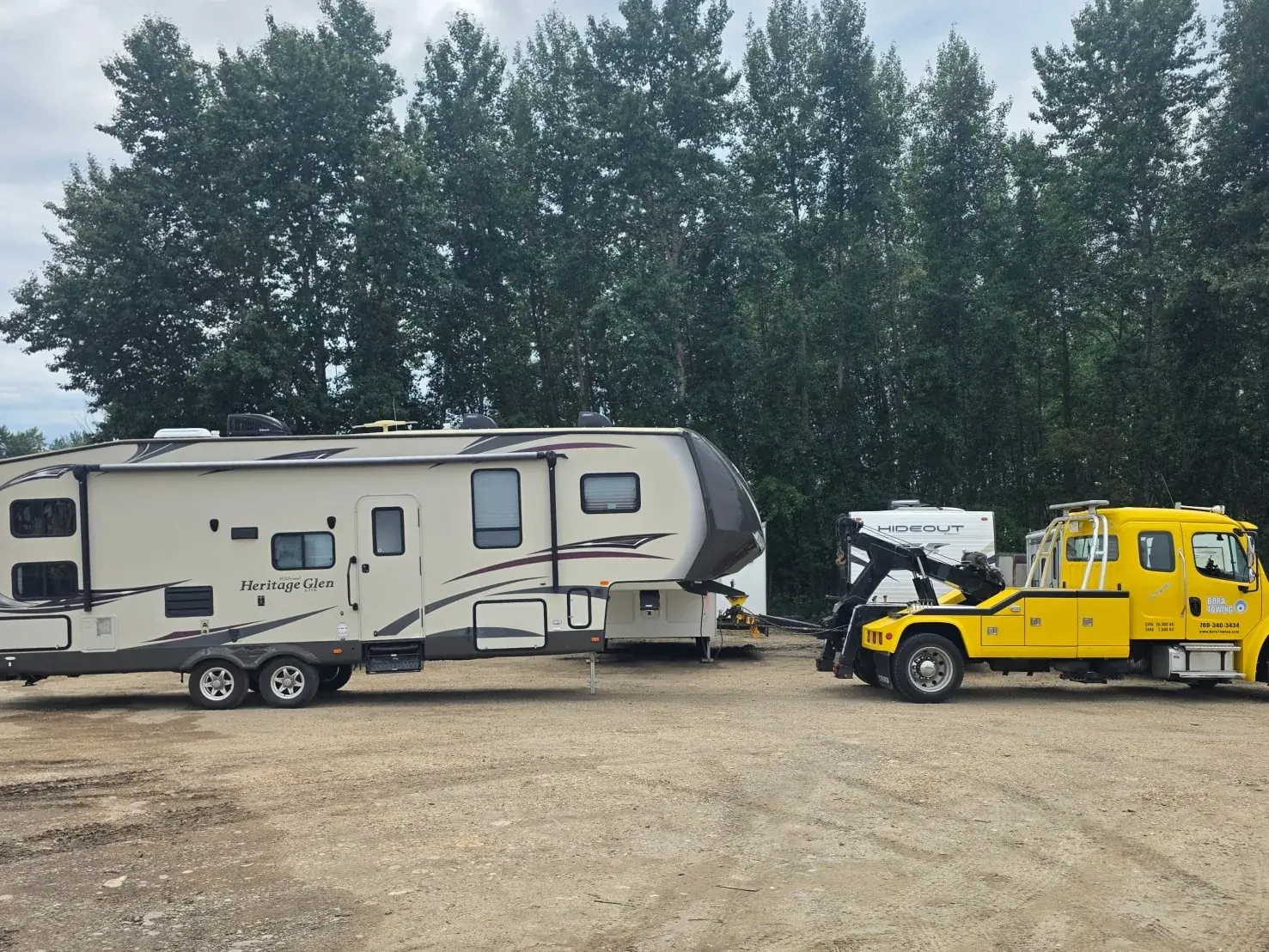 Bora Towing yellow wrecker recovering a Heritage Glen fifth-wheel RV in Edmonton